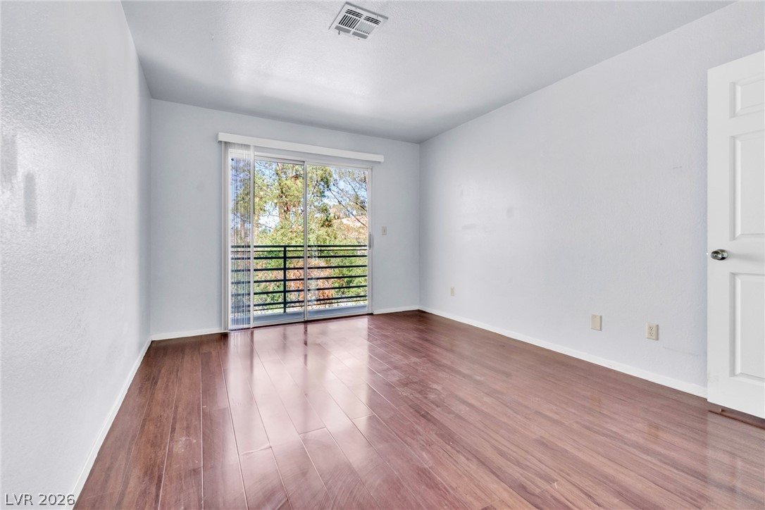6250 West Flamingo Road, Unit 98 Las Vegas, NV 89103 - Photo 24 of 40 Spare room with wood finished floors, baseboards, and visible vents