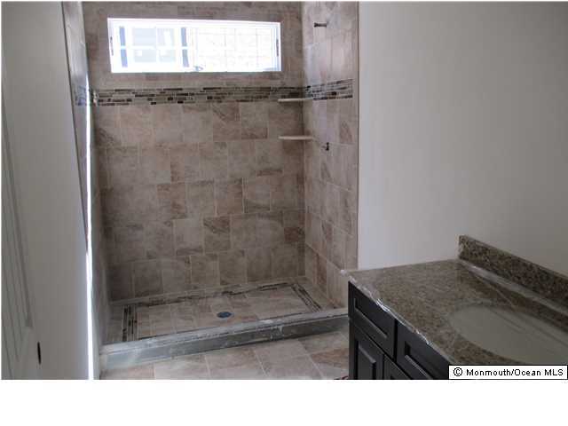 632 Harbor Road Brick, NJ 08724 - Photo 7 of 9 a bathroom with a shower a mirror and a sink