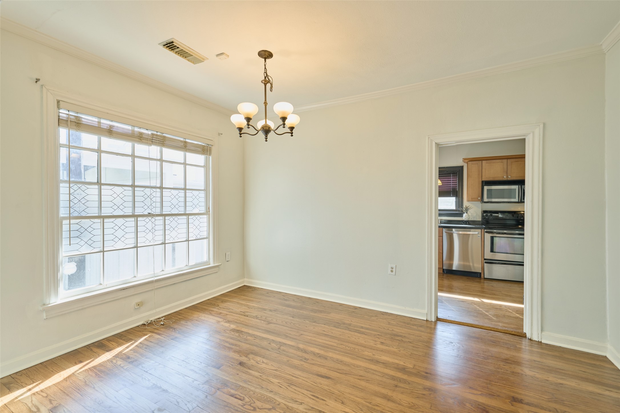 1111 Rutland Street Houston, TX 77008 - Photo 13 of 43 wooden floor in an empty room with a window