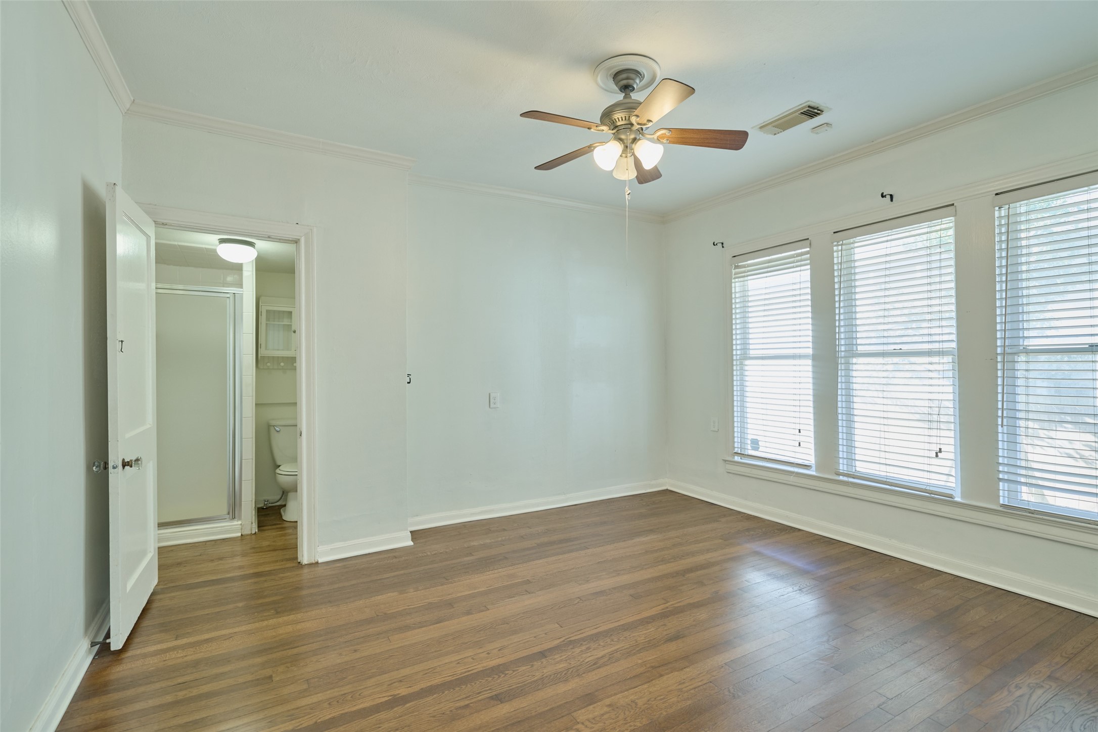 1111 Rutland Street Houston, TX 77008 - Photo 19 of 43 a view of empty room with wooden floor and fan