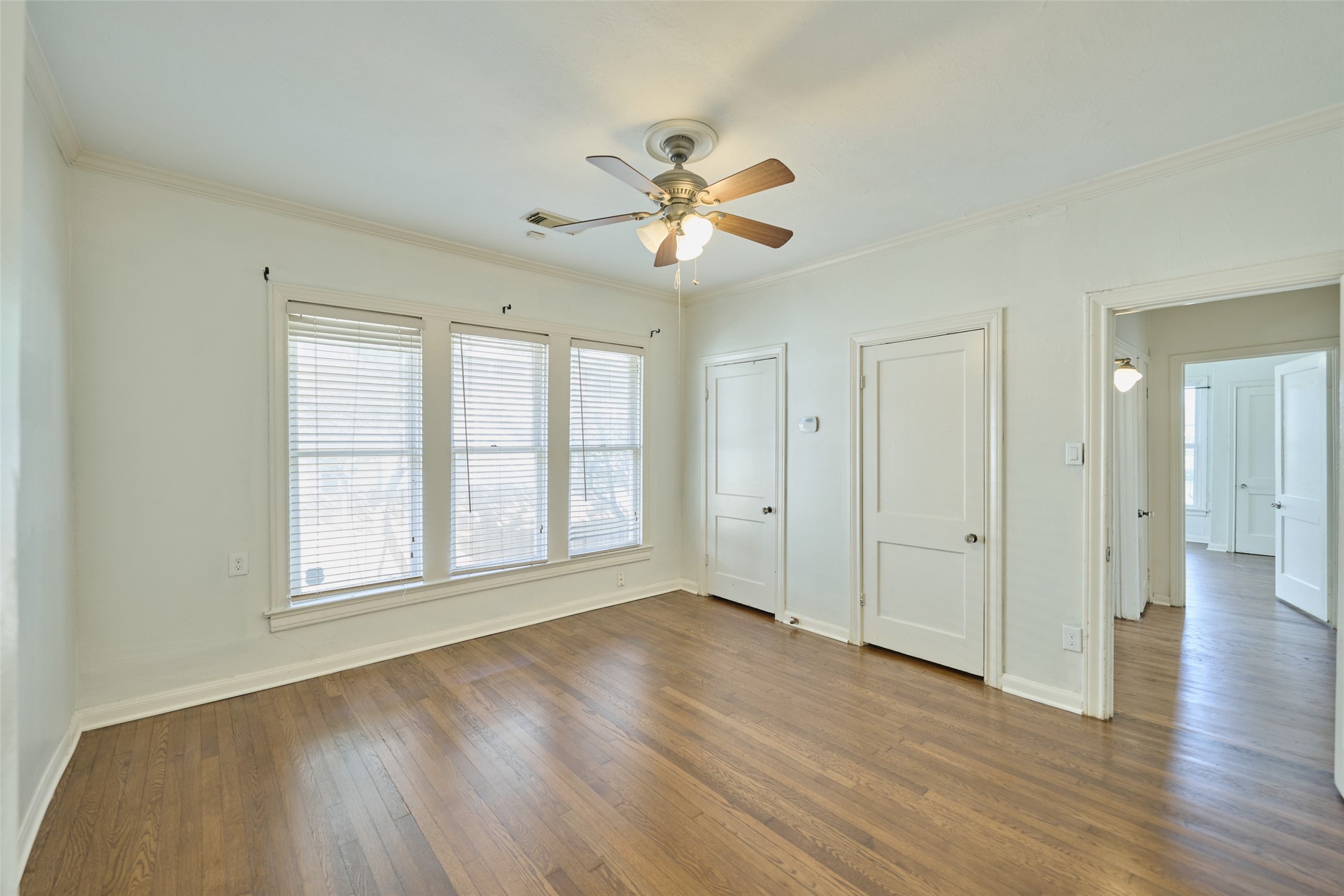 1111 Rutland Street Houston, TX 77008 - Photo 21 of 43 a view of an empty room with wooden floor and a window
