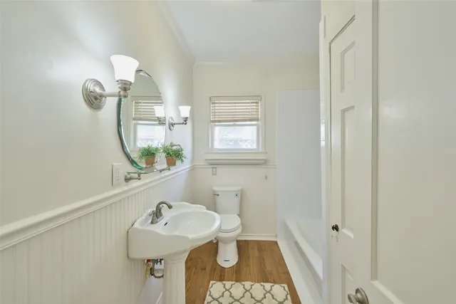 a bathroom with a sink mirror vanity and toilet