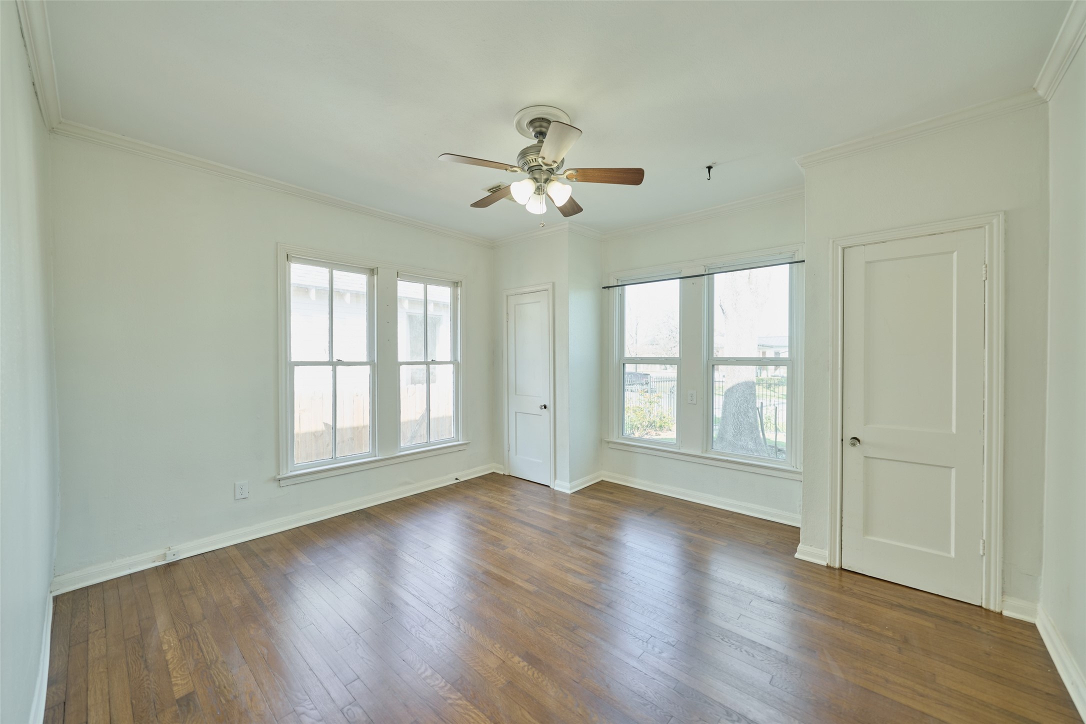 1111 Rutland Street Houston, TX 77008 - Photo 24 of 43 a view of an empty room with a window and wooden floor