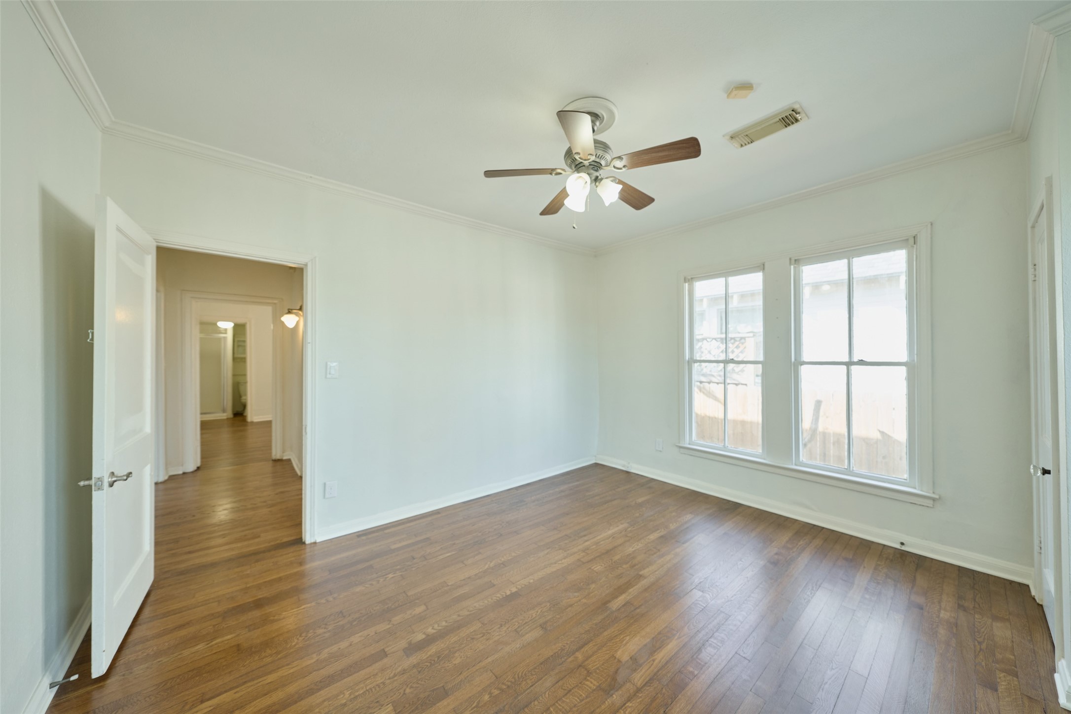 1111 Rutland Street Houston, TX 77008 - Photo 25 of 43 a view of empty room with wooden floor and fan