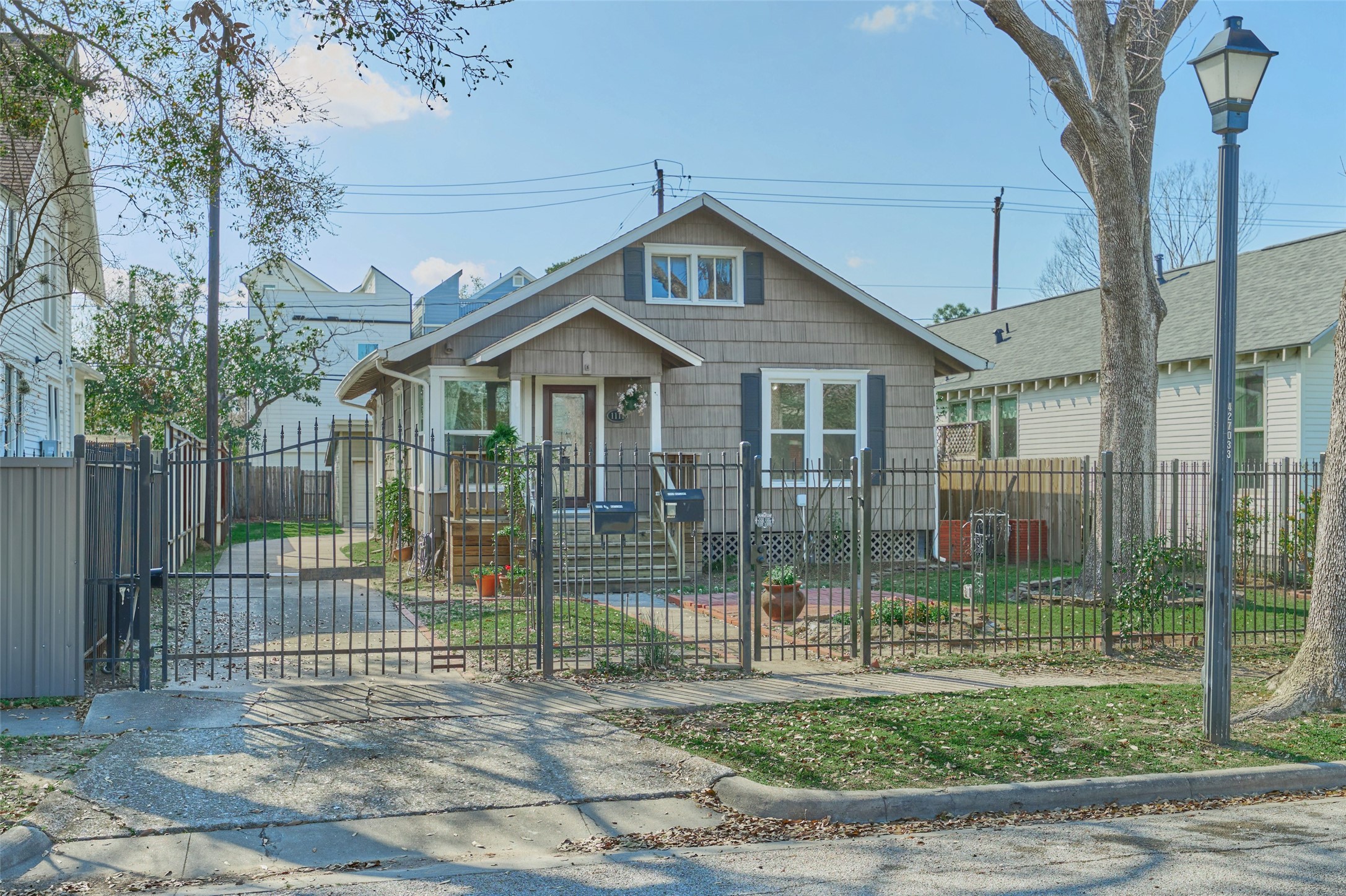 1111 Rutland Street Houston, TX 77008 - Photo 41 of 43 a view of a house with a small yard and a large tree