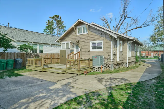 a kitchen with stainless steel appliances granite countertop a refrigerator a stove and a sink with wooden floor