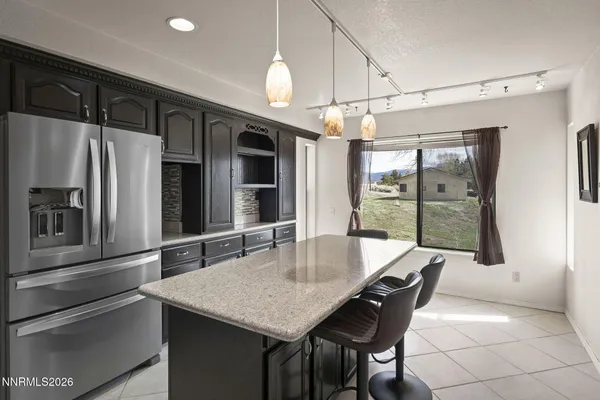 a kitchen with stainless steel appliances granite countertop a refrigerator a sink and a stove