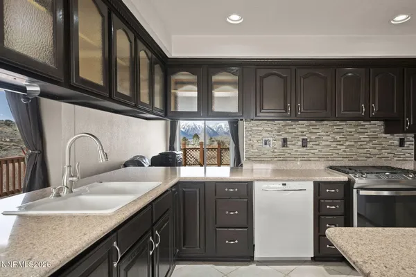 a kitchen with stainless steel appliances granite countertop a sink stove and cabinets