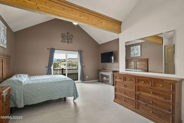 a bedroom with a bed and a television