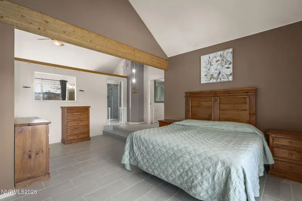 a bedroom with a bed and a couch