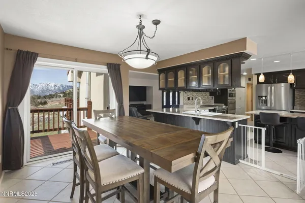 a dining room with furniture a chandelier and wooden floor