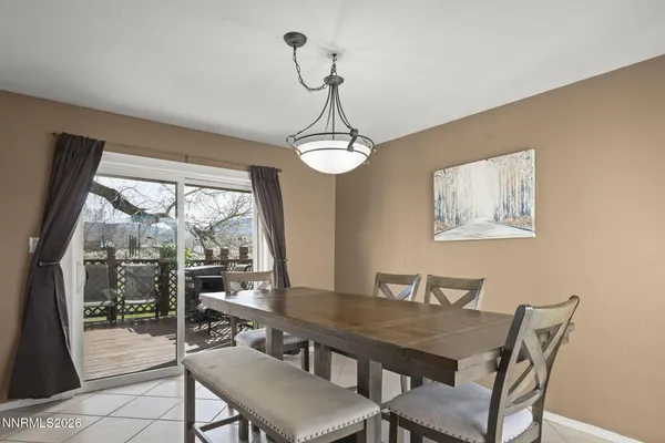 a view of a dining room with furniture wooden floor and a chandelier