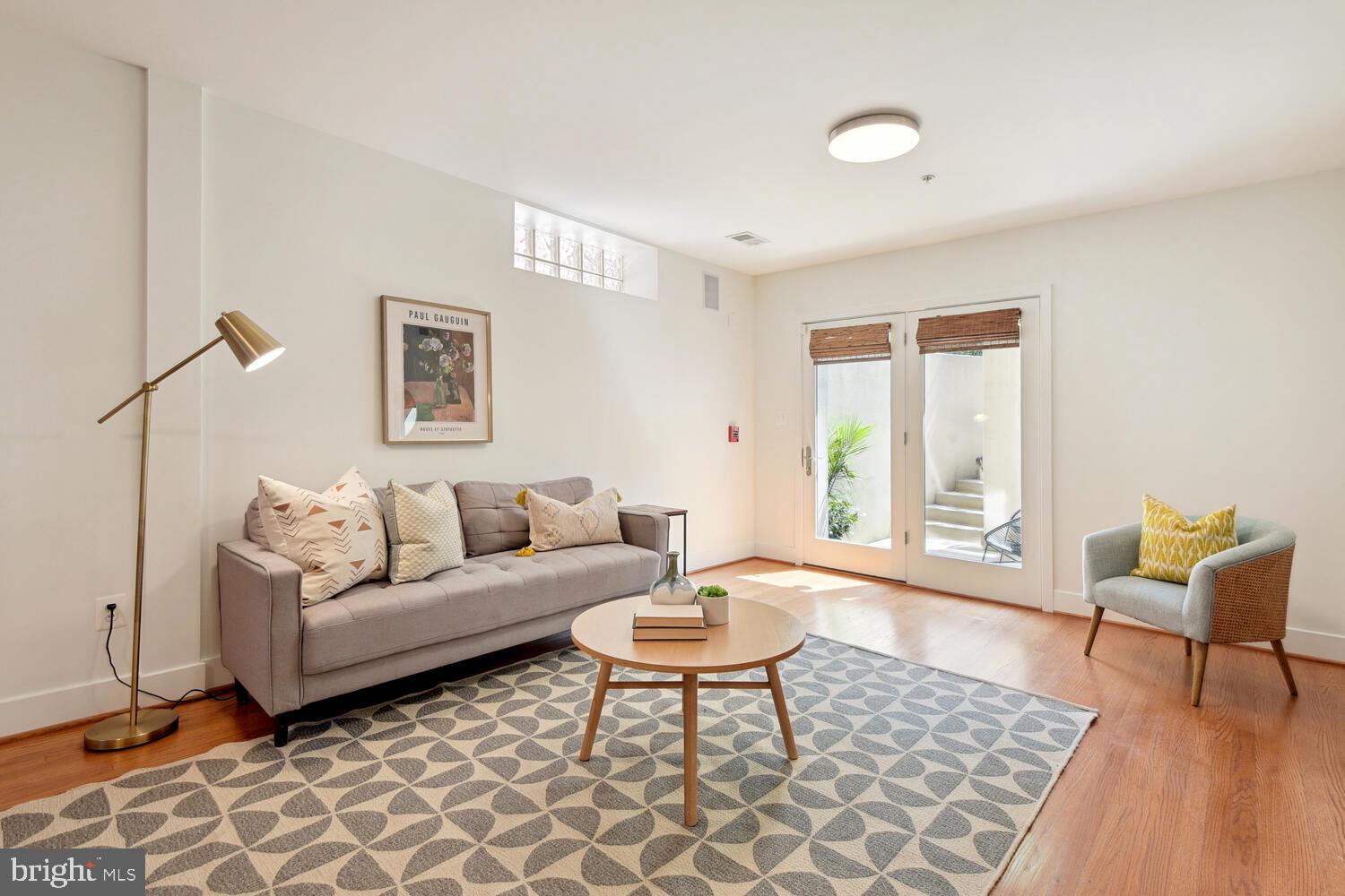 1317 Shepherd Street Northwest, Unit A Washington, DC 20011 - Photo 1 of 17 a living room with furniture a rug a lamp and a window