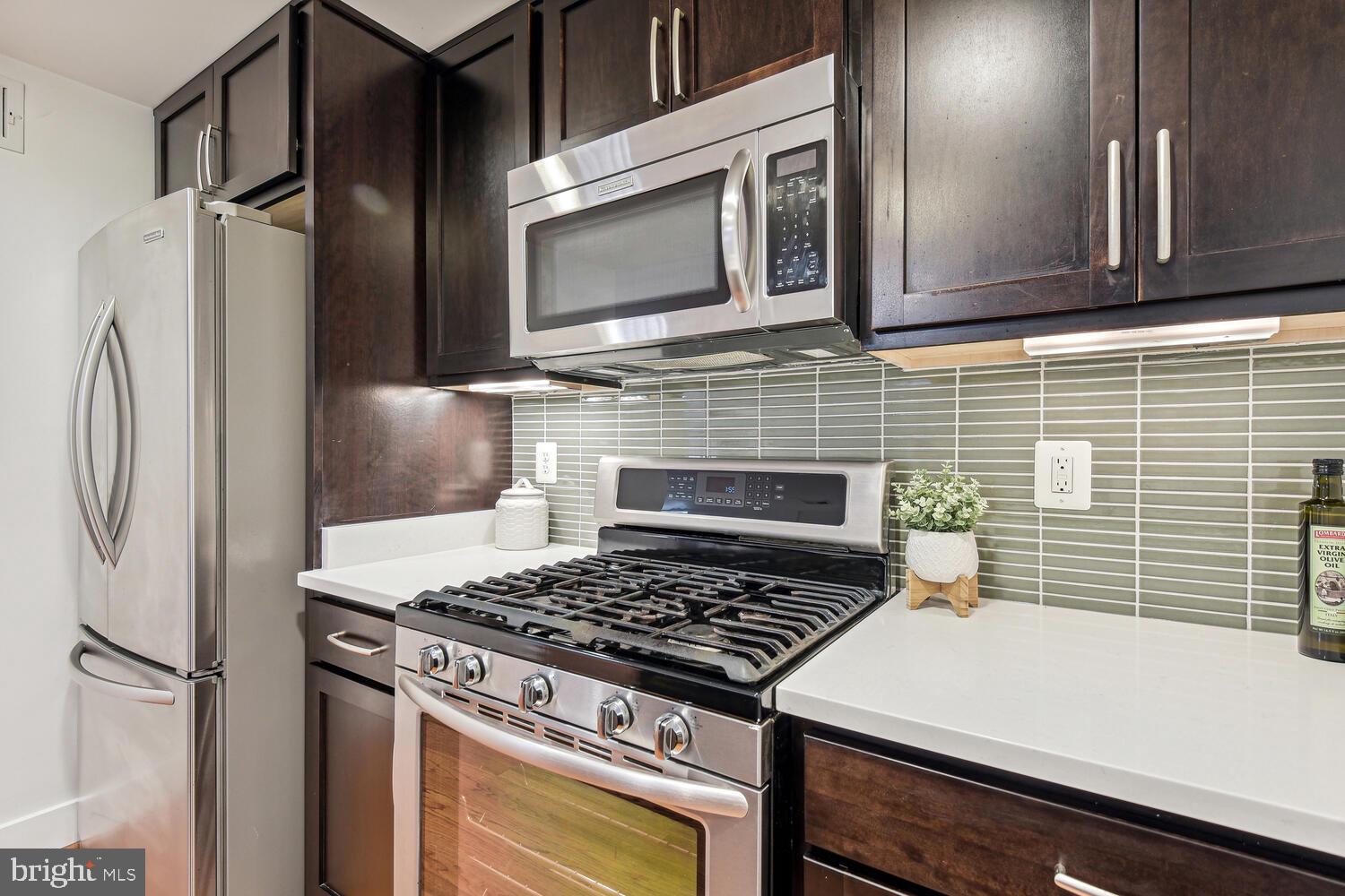 1317 Shepherd Street Northwest, Unit A Washington, DC 20011 - Photo 11 of 17 a kitchen with stainless steel appliances a stove a refrigerator and a microwave