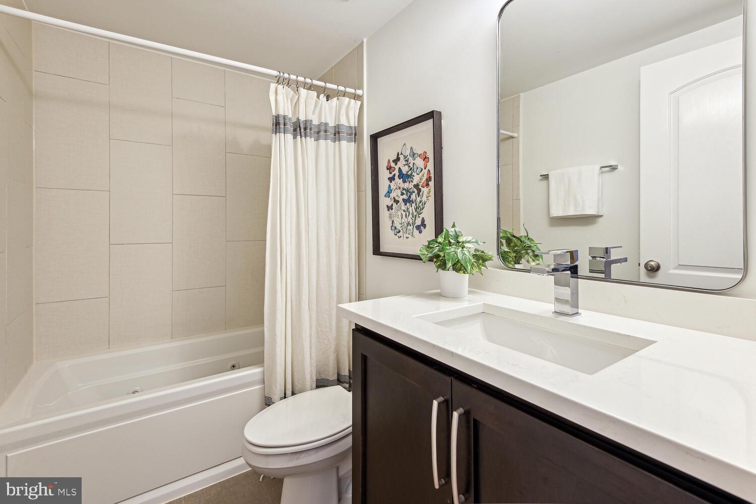 1317 Shepherd Street Northwest, Unit A Washington, DC 20011 - Photo 15 of 17 a bathroom with a granite countertop sink toilet and shower