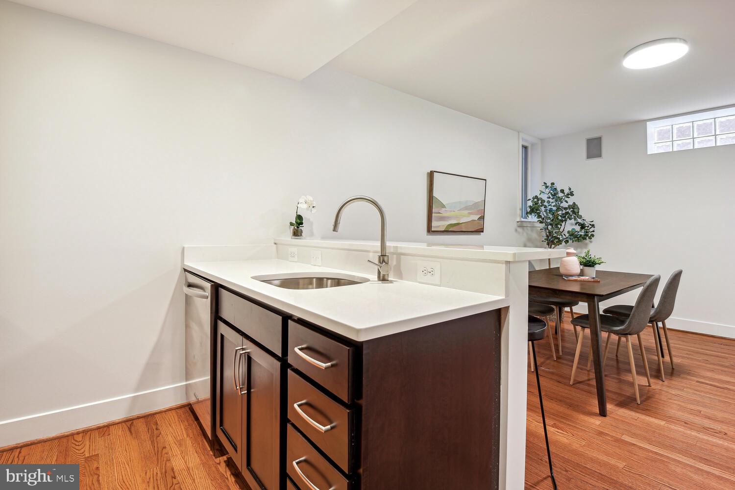 1317 Shepherd Street Northwest, Unit A Washington, DC 20011 - Photo 10 of 17 a view of a kitchen area with furniture and wooden floor