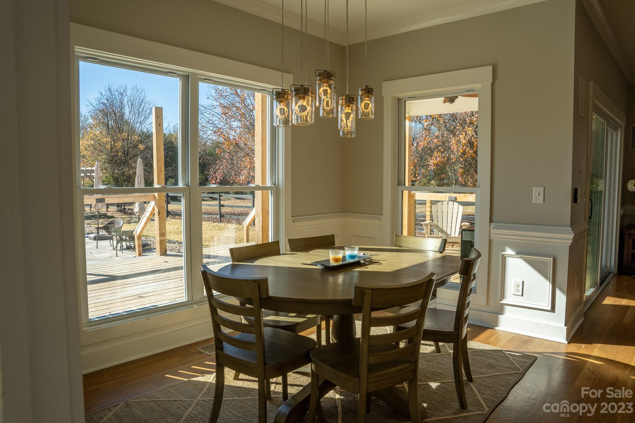 1411 Mary Ellen Drive Fort Mill, SC 29708 - Photo 23 of 37 a dining room with furniture a chandelier and wooden floor
