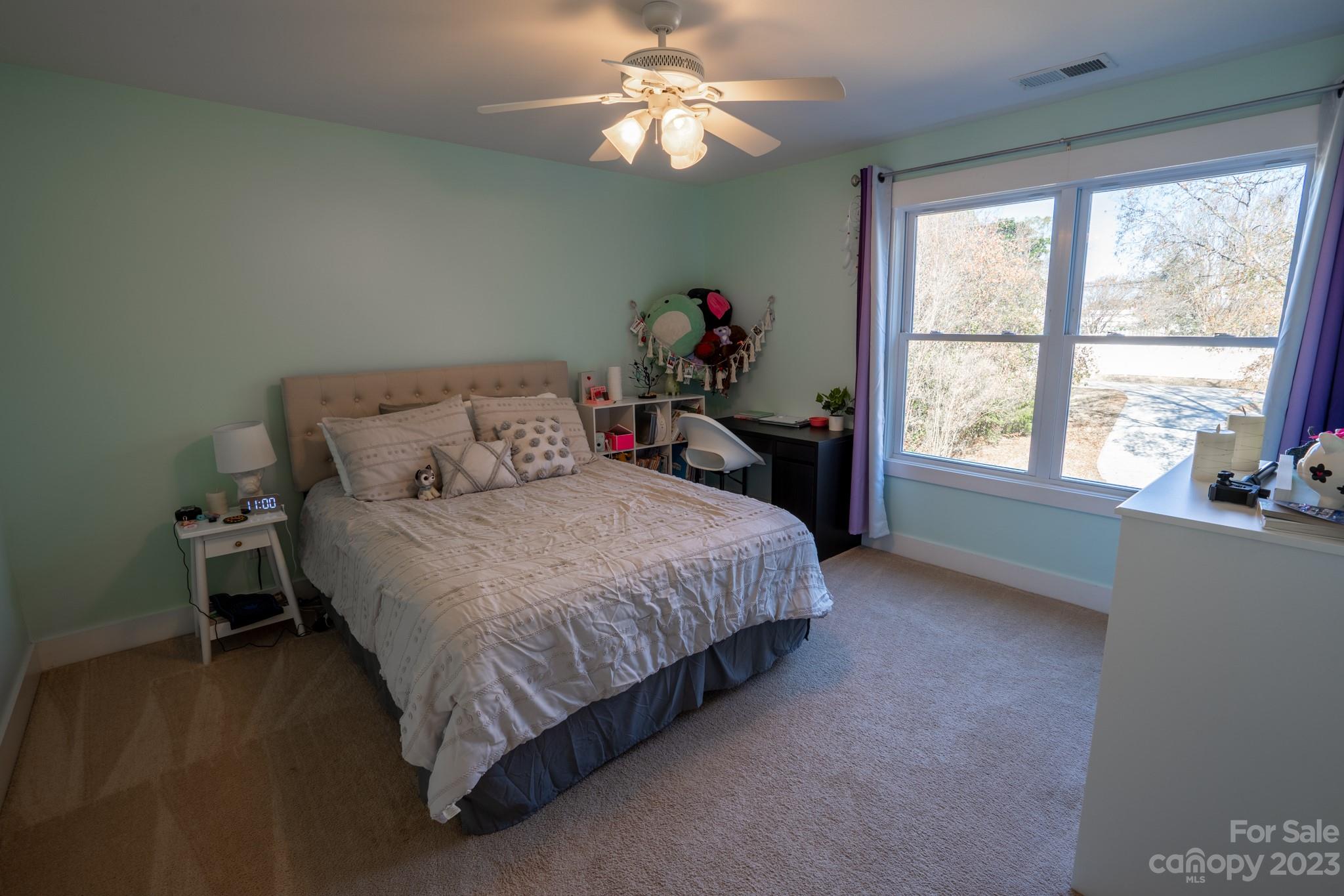 1411 Mary Ellen Drive Fort Mill, SC 29708 - Photo 32 of 37 a spacious bedroom with a bed and a chandelier