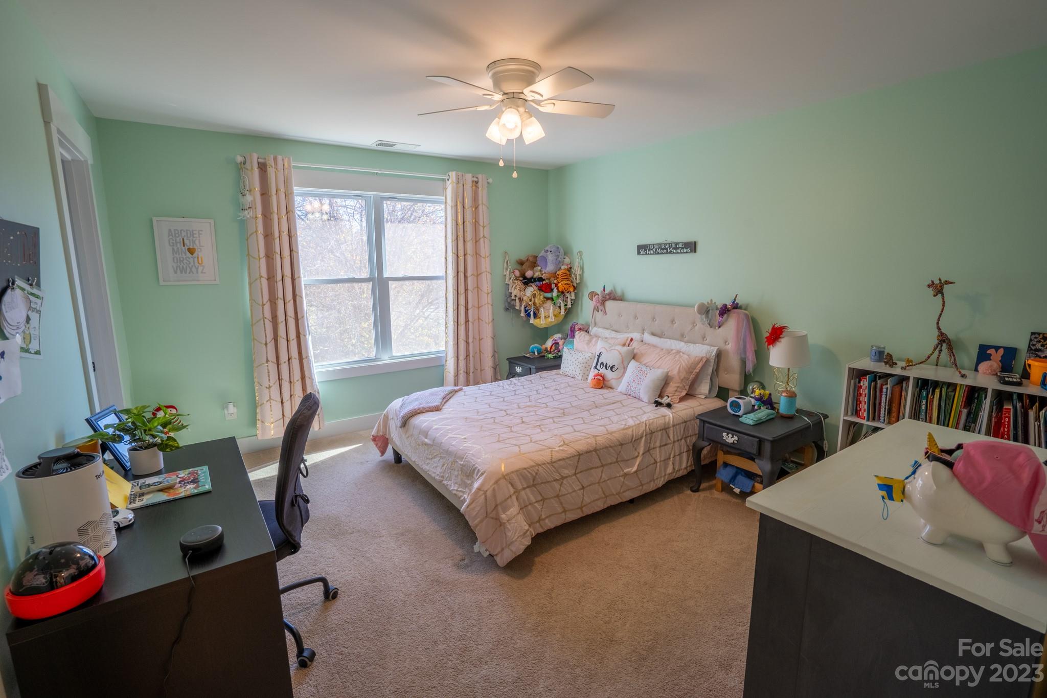 1411 Mary Ellen Drive Fort Mill, SC 29708 - Photo 34 of 37 a bedroom with a bed and a chandelier