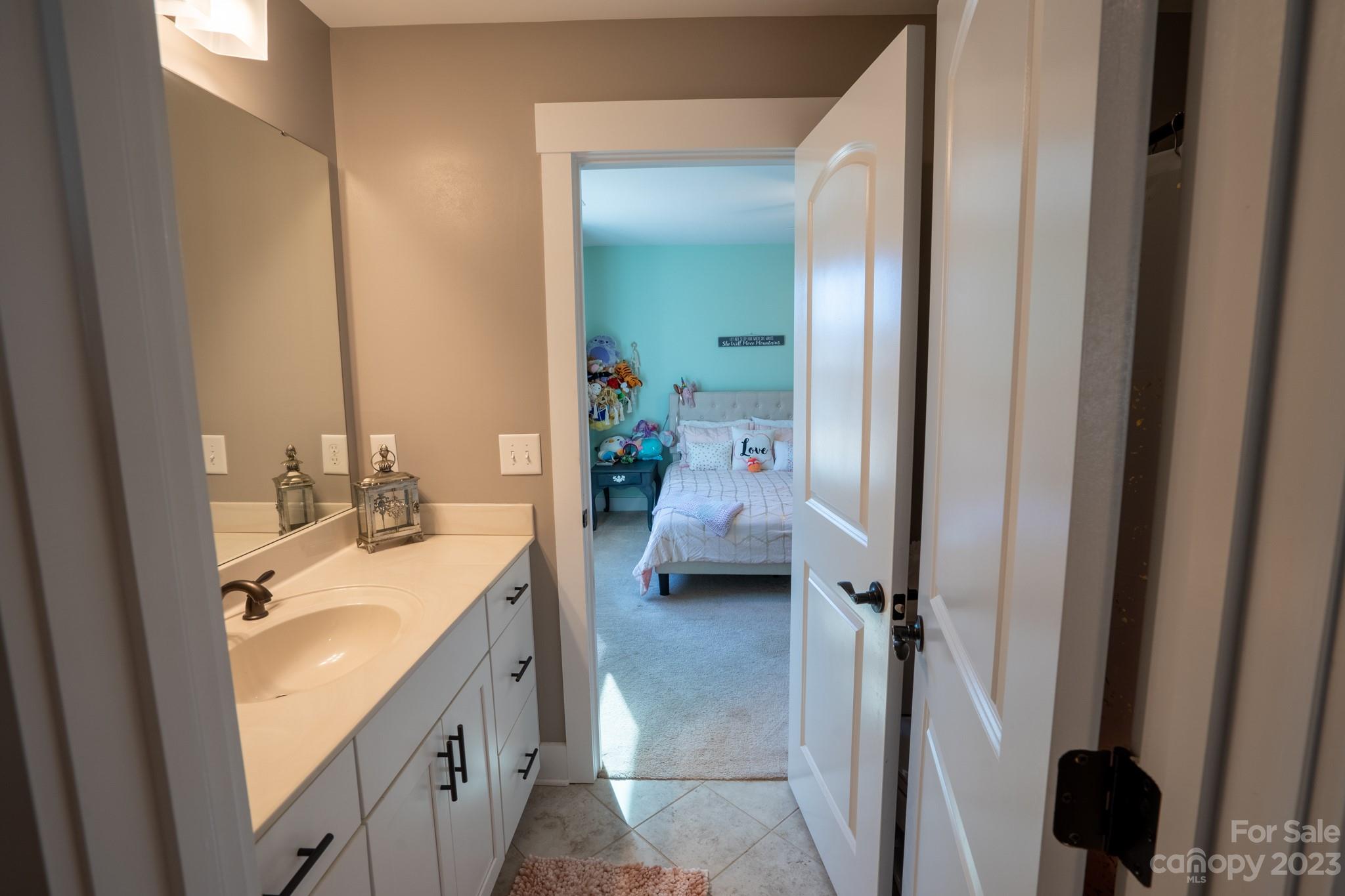 1411 Mary Ellen Drive Fort Mill, SC 29708 - Photo 35 of 37 a en suite bathroom with a double vanity sink a mirror and a shower