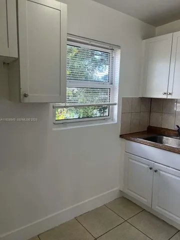 a kitchen with a window a sink and a window