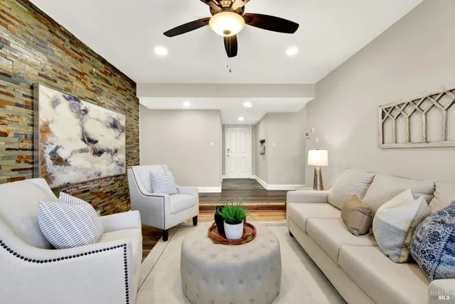 a living room with furniture and a chandelier
