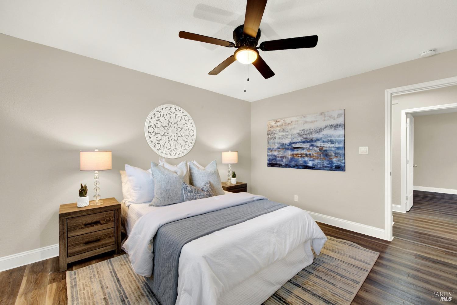 314 Tulip Street Fairfield, CA 94533 - Photo 7 of 11 a bedroom with a bed and a chandelier