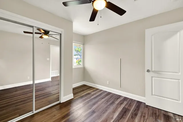 a view of an empty room and wooden floor