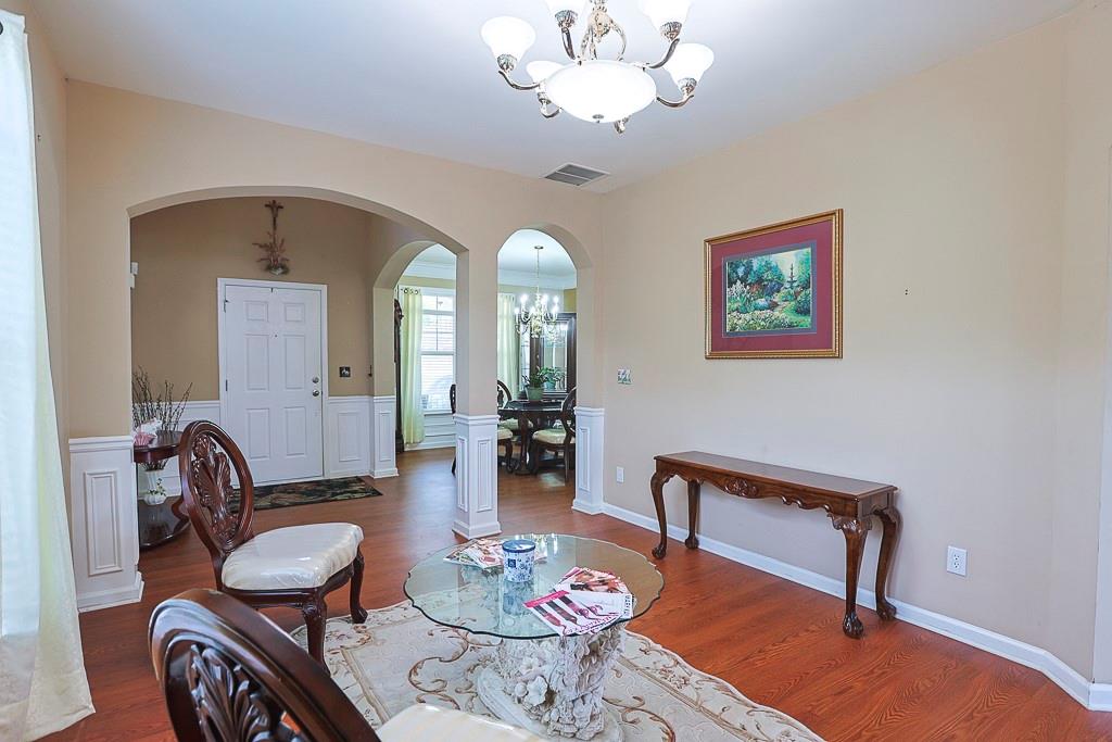 300 Hampton Place Canton, GA 30115 - Photo 10 of 82 a view of a livingroom and dining room with furniture wooden floor and a chandelier
