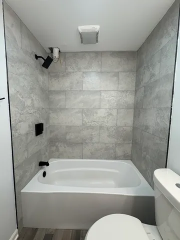 a bathroom with a sink a toilet and a bathtub