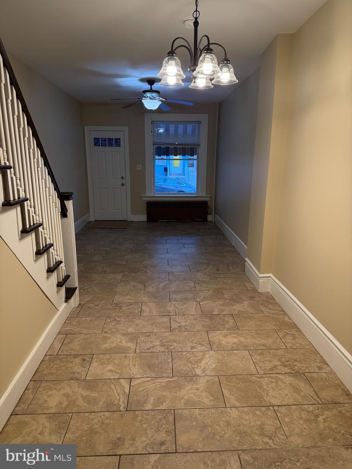1255 Buttonwood Street Reading, PA 19604 - Photo 3 of 14 a view of a livingroom with a fireplace a chandelier fan and windows