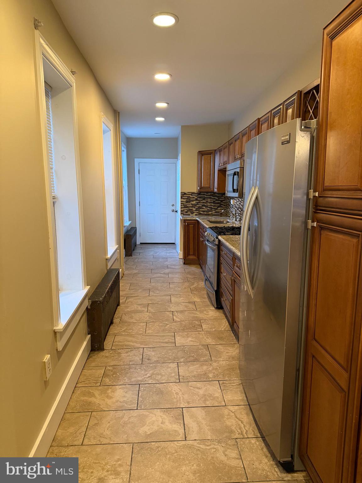 1255 Buttonwood Street Reading, PA 19604 - Photo 4 of 14 a kitchen with stainless steel appliances granite countertop a refrigerator and a stove
