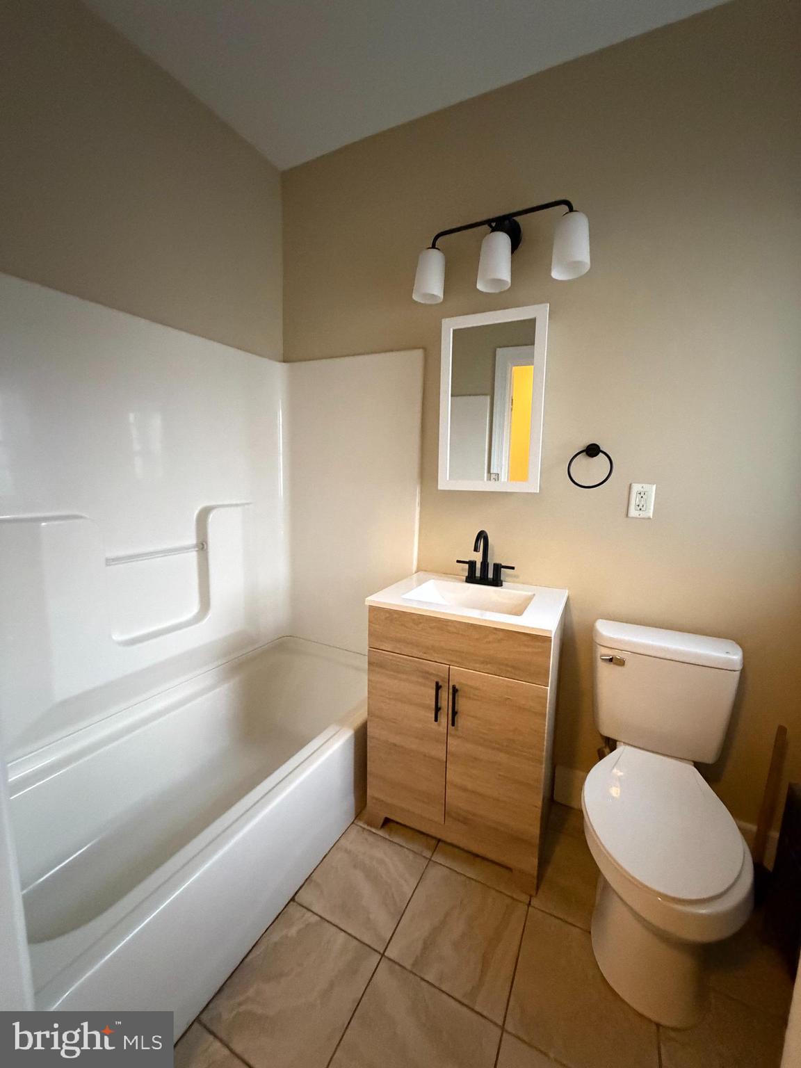 1255 Buttonwood Street Reading, PA 19604 - Photo 10 of 14 a bathroom with a sink mirror vanity and toilet