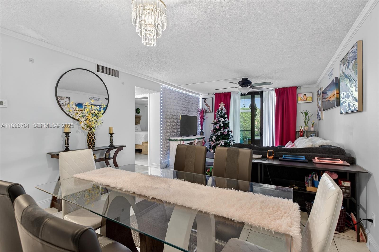 6195 Rock Island Road, Unit 103 Tamarac, FL 33319 - Photo 13 of 27 a view of a dining room with furniture and a chandelier