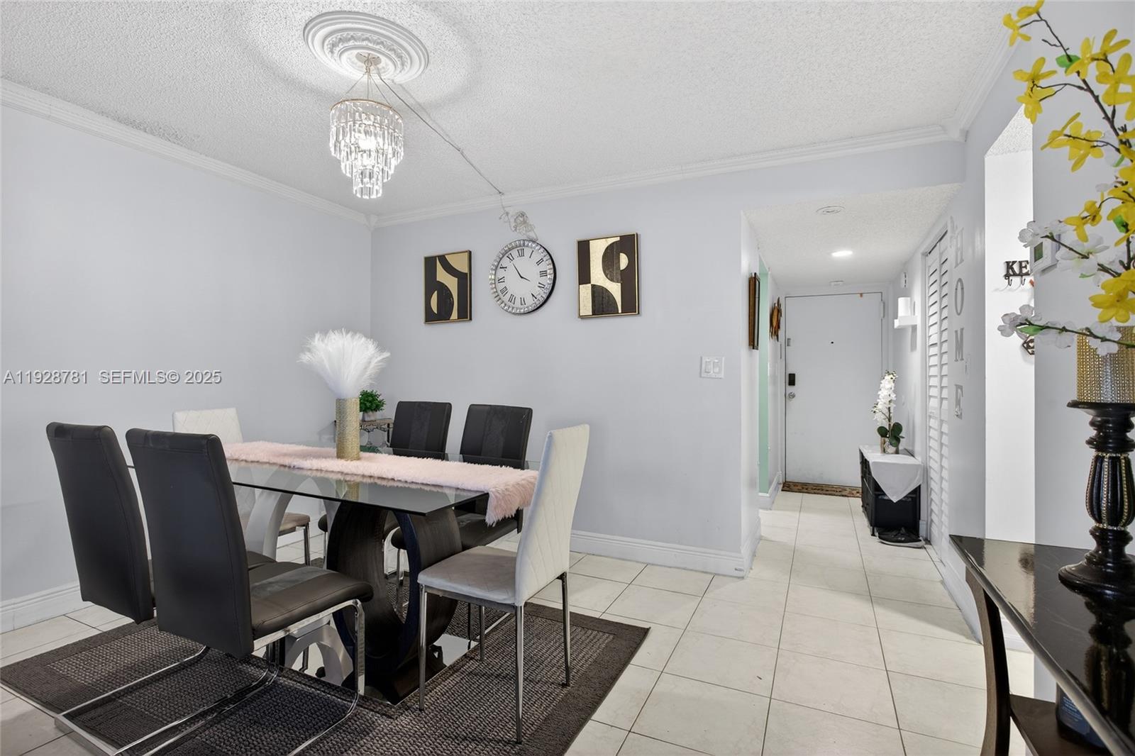 6195 Rock Island Road, Unit 103 Tamarac, FL 33319 - Photo 14 of 27 a view of a dining room with furniture and a chandelier