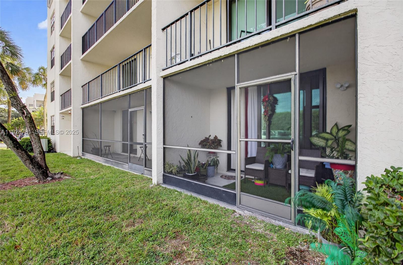 6195 Rock Island Road, Unit 103 Tamarac, FL 33319 - Photo 2 of 27 a view of a house with backyard and garden