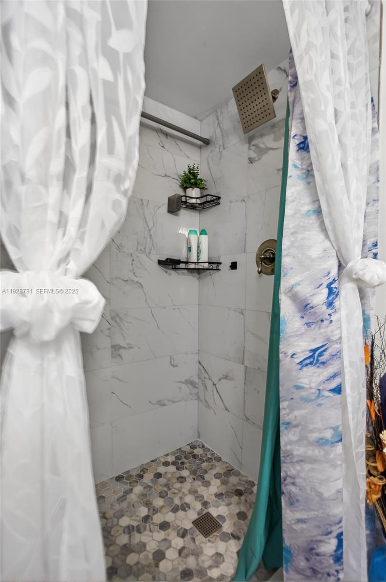 6195 Rock Island Road, Unit 103 Tamarac, FL 33319 - Photo 21 of 27 a bathroom with a sink and a shower