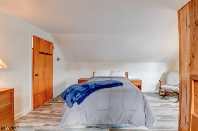 a bedroom with a bed and a mirror