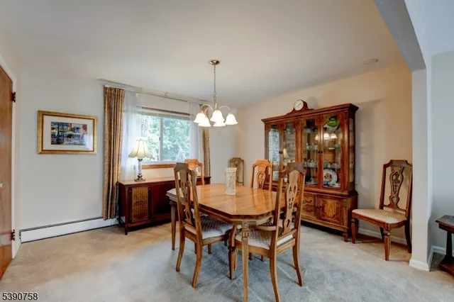a view of a dining room with furniture and chandelier