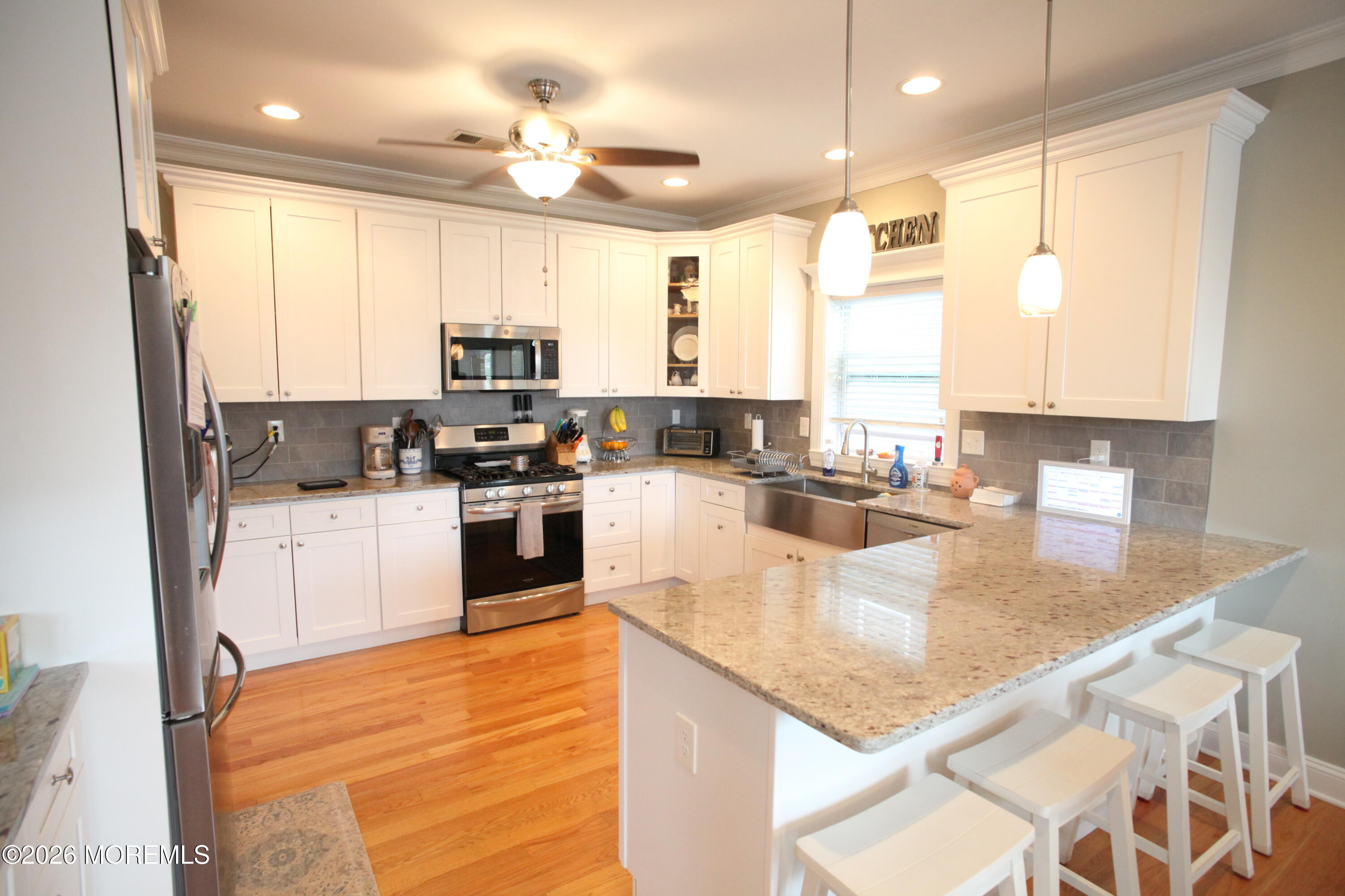 107 Waldron Road Toms River, NJ 08753 - Photo 2 of 20 a kitchen with stainless steel appliances granite countertop a stove a sink and a microwave