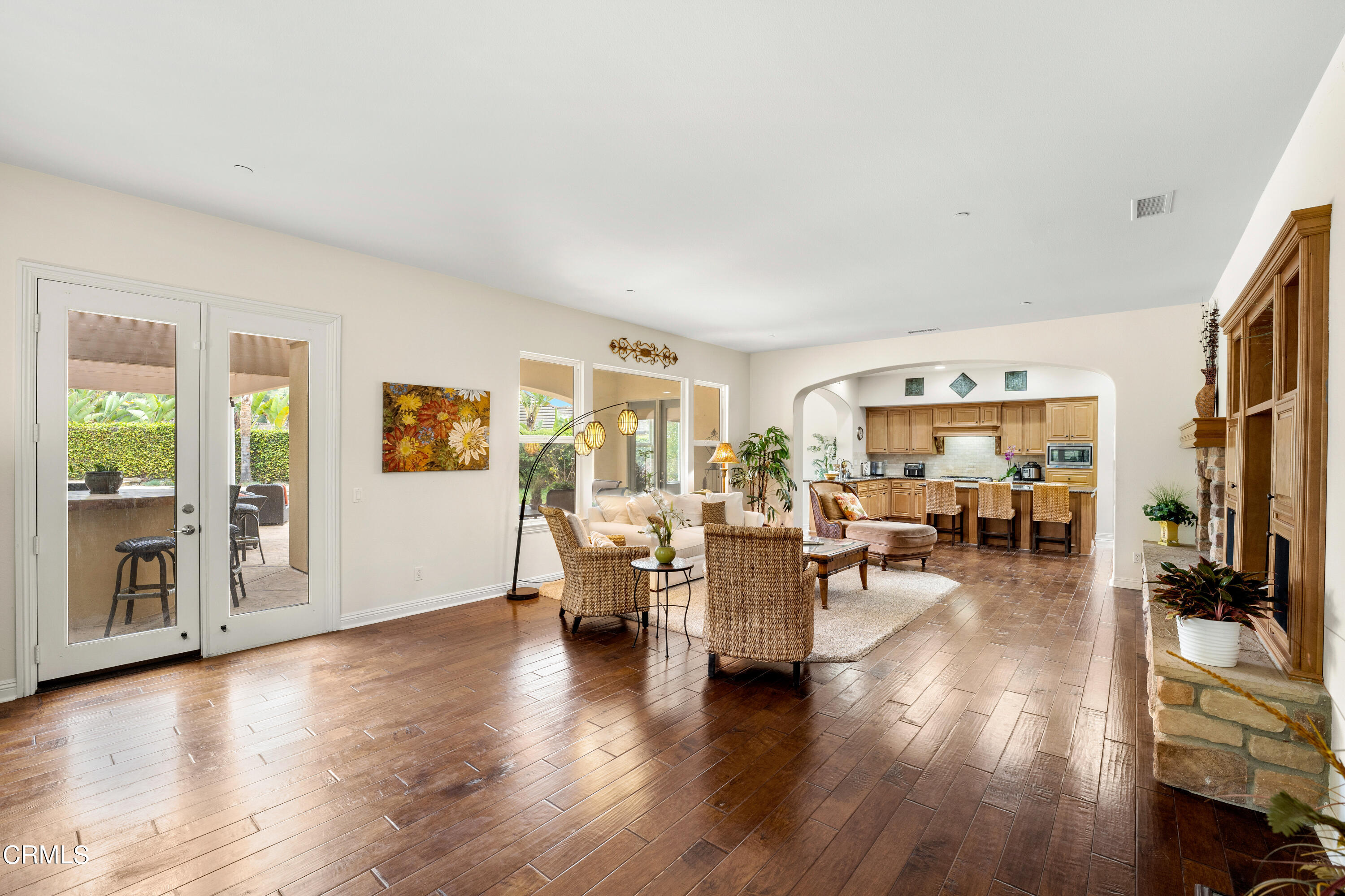2510 Worth Way Camarillo, CA 93012 - Photo 37 of 75 a living room with lots of furniture a lamp wooden floor and a large window