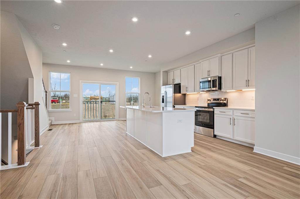 106 Scenic Ridge Drive Venetia, PA 15367 - Photo 14 of 32 a kitchen with stainless steel appliances kitchen island wooden floors wooden cabinets and center island