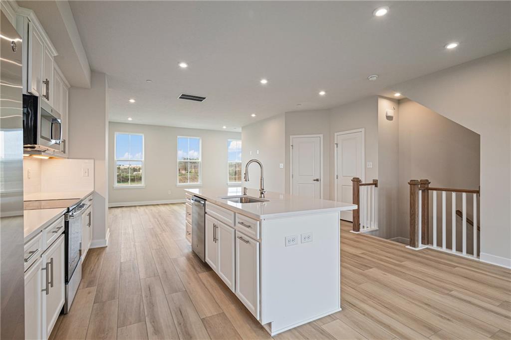 106 Scenic Ridge Drive Venetia, PA 15367 - Photo 21 of 32 a large kitchen with stainless steel appliances granite countertop a lot of counter space and wooden floors