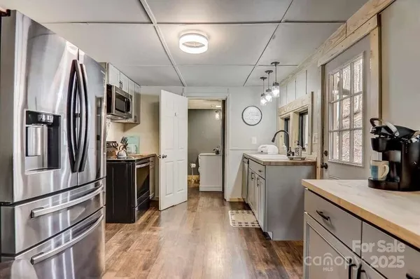 a kitchen with a refrigerator and a sink