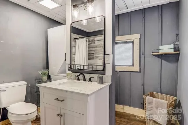a bathroom with a toilet sink and mirror