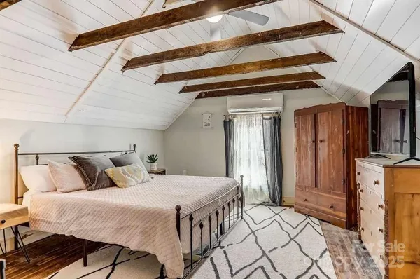 a bedroom with a bed and a table