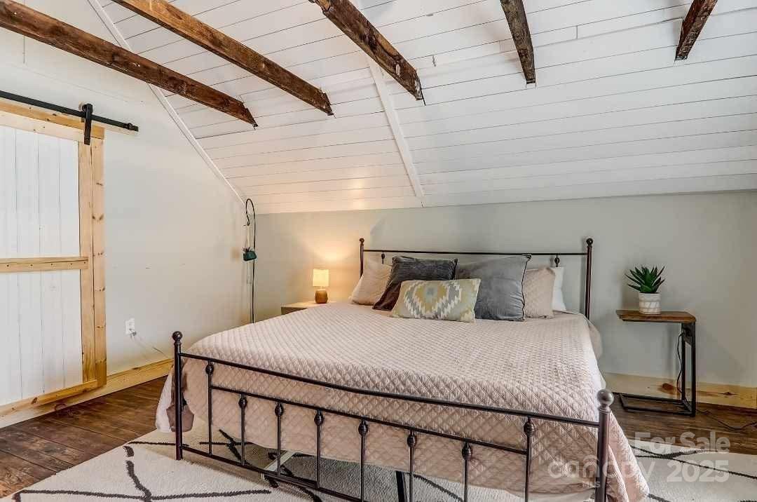 14 Old Mater Farm Road Sylva, NC 28779 - Photo 22 of 26 a bedroom with a bed and wooden floor