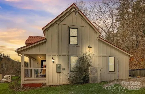 a view of house with backyard