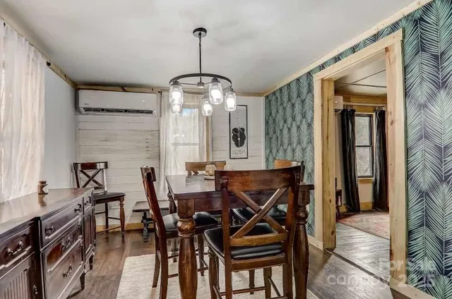 a view of a dining room with furniture and a chandelier