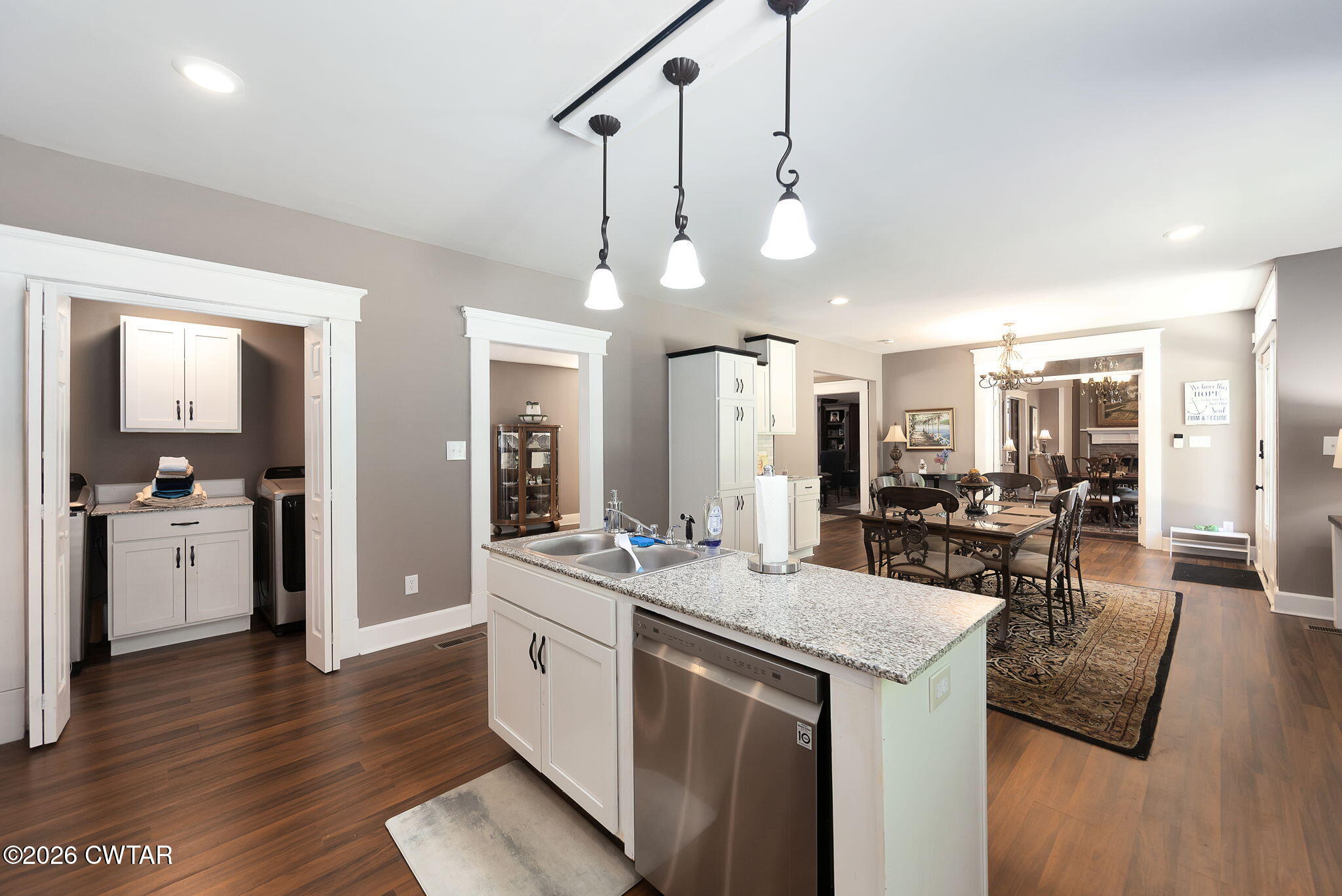 554 East Main Street Jackson, TN 38301 - Photo 19 of 60 a large kitchen with a counter space a sink appliances and living room view